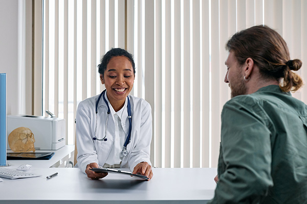 doctor discussing notes with patient in office