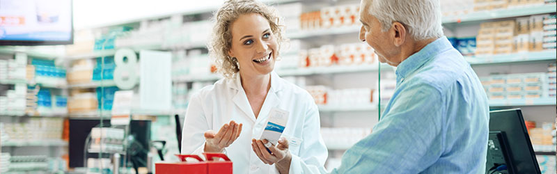 pharmacist talking to senior customer about a medicine