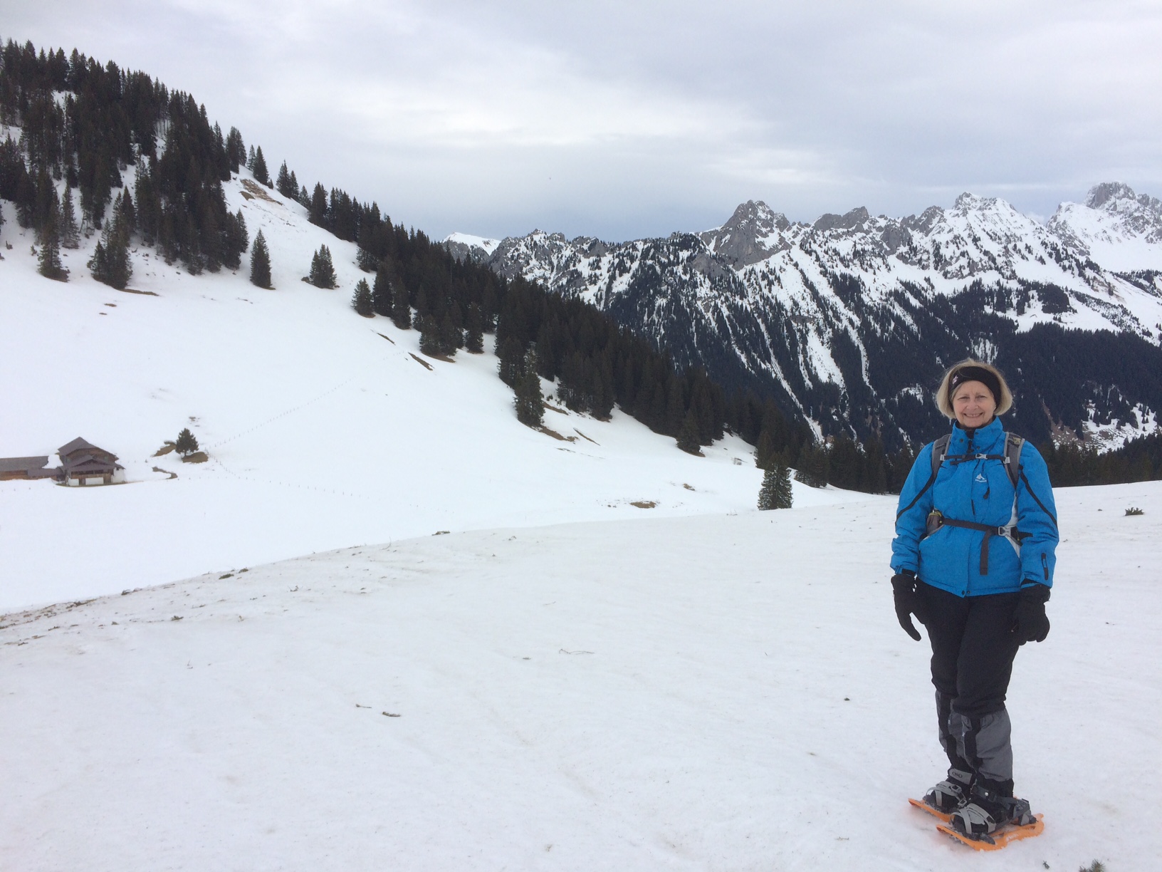 Lynn Denton in snow shoes on a Swiss mountain top