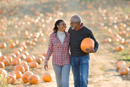 retiree couple in pumpkin patch