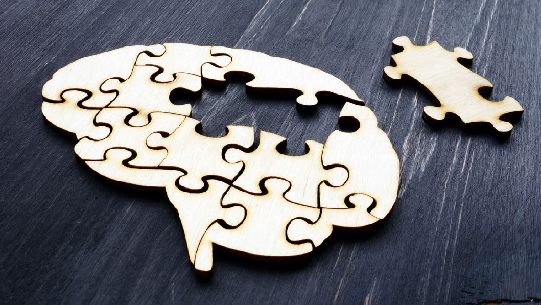 graphic of brain puzzle on wood table